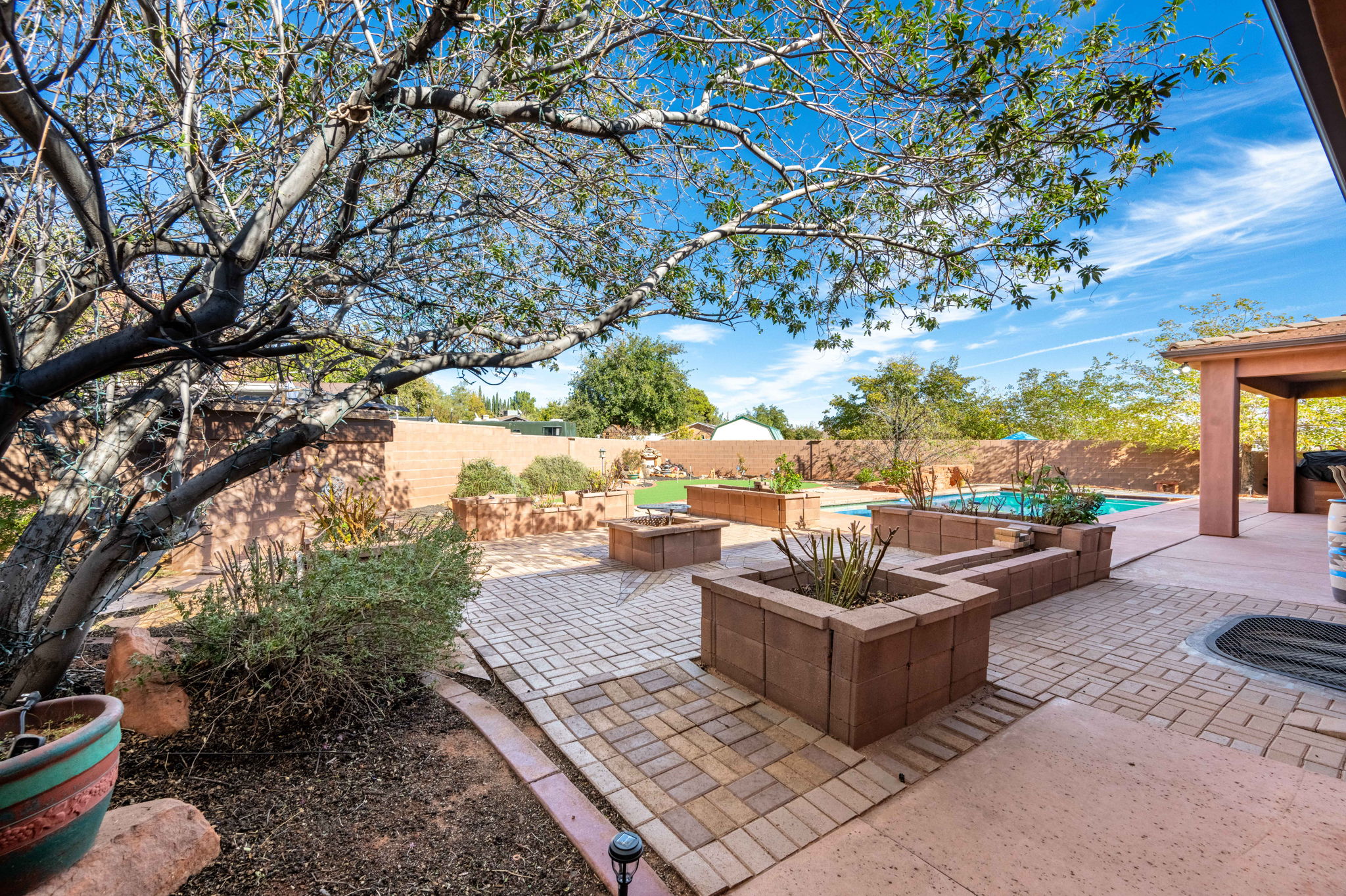 Fenced backyard with a patio and an outdoor living space with a fire pit