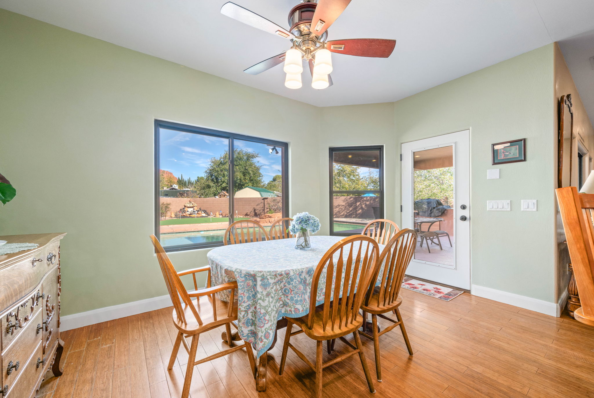 Dining area with light wood-style flooring and ceiling fan
