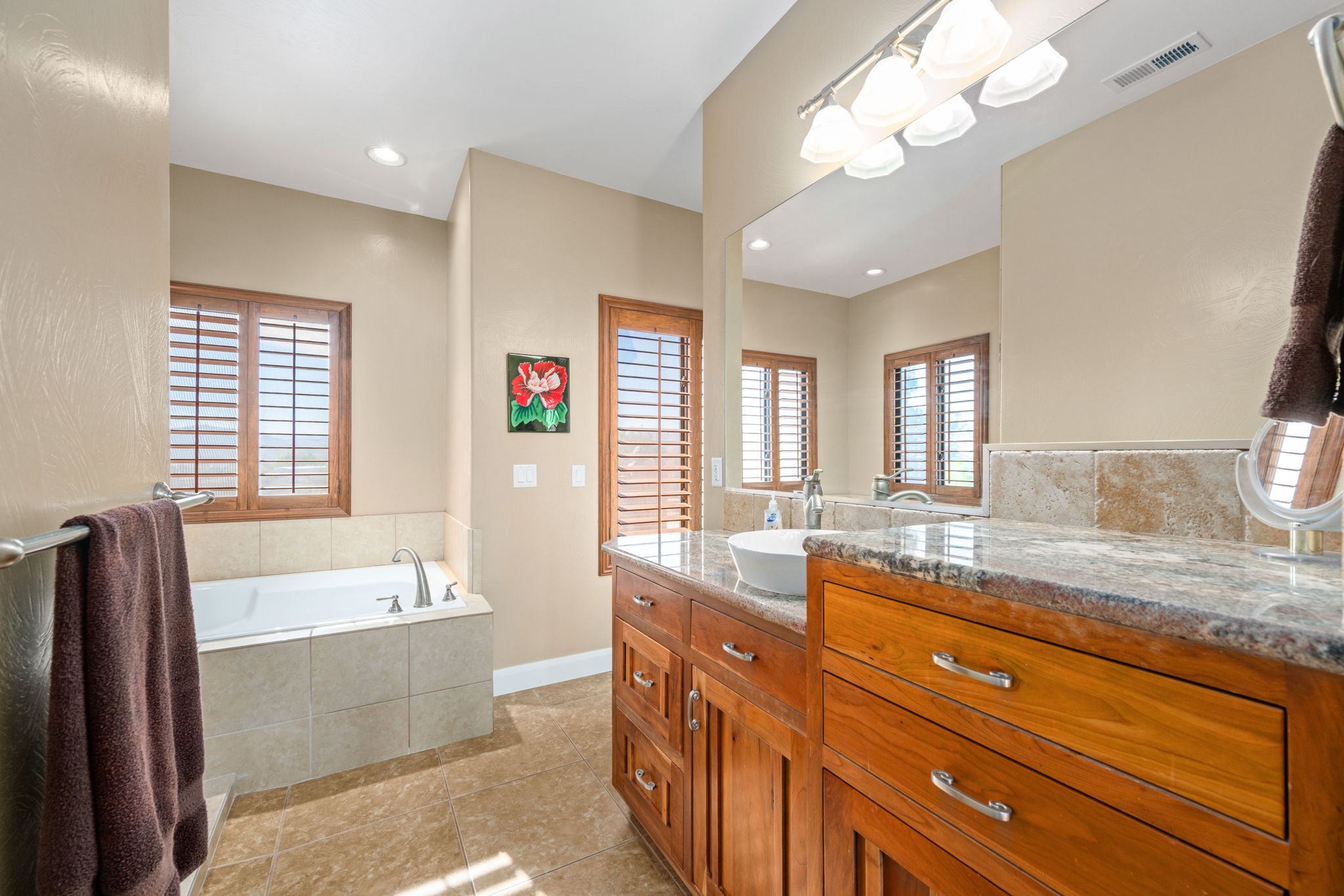 Full bathroom with vanity, a garden tub, light tile patterned flooring, and recessed lighting