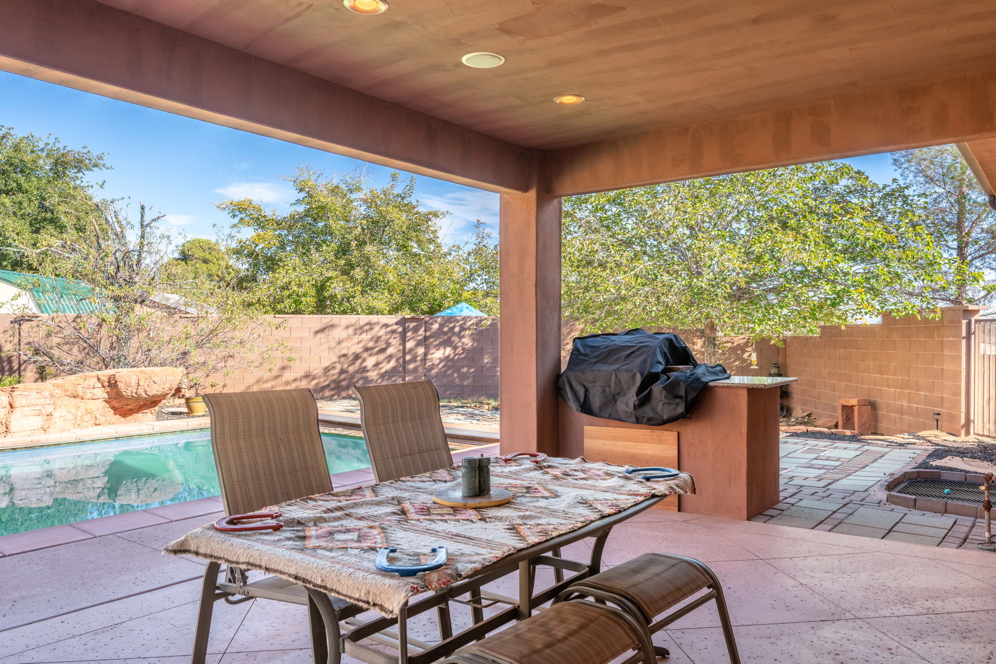 Fenced backyard with a patio, a grill, and outdoor dining space