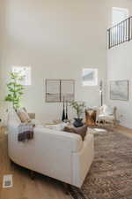 Living room featuring wood finished floors and a high ceiling