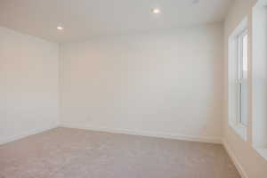 Unfurnished room featuring light carpet and recessed lighting