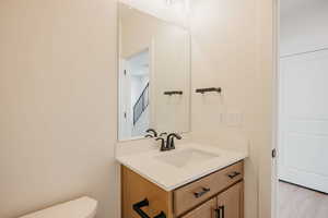 Half bath with vanity and toilet