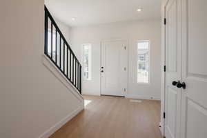 Foyer featuring light wood-style floors and recessed lighting