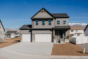 View of front of property with a mountain view, board and batten siding, and roof with shingles