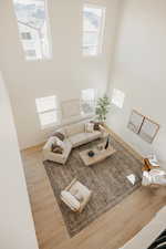 Living area with wood finished floors and a high ceiling