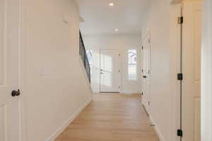 Corridor featuring light wood-style flooring and recessed lighting