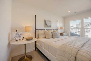 Bedroom featuring light carpet and recessed lighting
