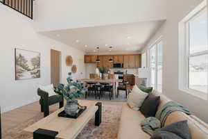 Living area with light wood-style floors and recessed lighting