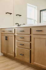 Bathroom view of vanity and wood finished floors