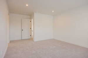 Unfurnished room featuring light carpet and recessed lighting