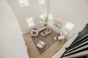 Living room with wood finished floors and a high ceiling