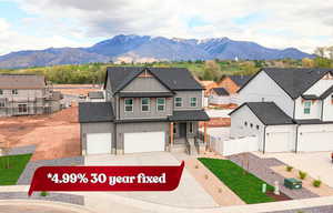 View of front of house featuring board and batten siding, a porch, a shingled roof, and a mountain view