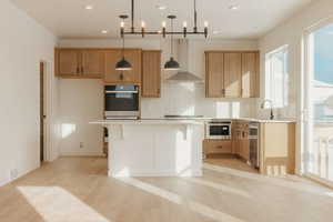 Kitchen with light countertops, a kitchen breakfast bar, tasteful backsplash, and stainless steel appliances