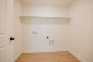 Laundry area with light wood-type flooring, washer hookup, and electric dryer hookup