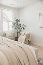 Carpeted bedroom featuring baseboards