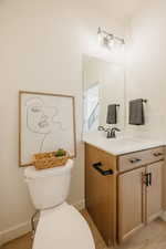 Half bathroom with vanity and toilet