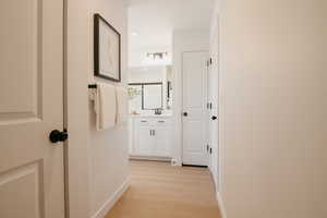 Corridor featuring light wood-style floors and recessed lighting