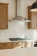 Kitchen with stainless steel appliances, tasteful backsplash, and light stone countertops