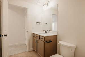 Half bathroom with vanity and light wood-type flooring