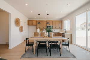 Dining area featuring light wood-style flooring and recessed lighting