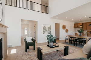 Living room featuring recessed lighting, light wood-style flooring, and a fireplace
