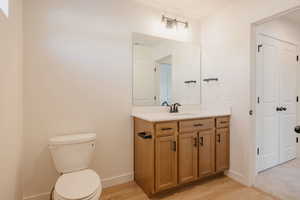 Half bath featuring vanity and light wood-style flooring