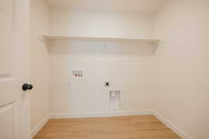 Laundry room with light wood-style flooring, hookup for a washing machine, and electric dryer hookup