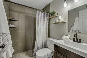 Full bathroom featuring a walk in shower stall and vanity