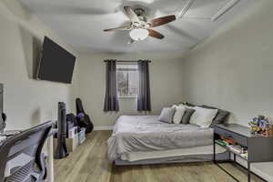 Bedroom featuring light wood-type flooring and ceiling fan