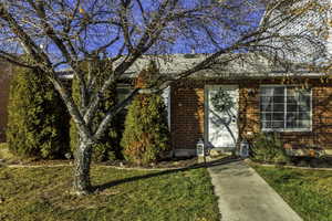 View of front of property featuring brick siding and a front yard