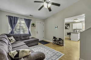 Living room featuring light wood-style floors and ceiling fan