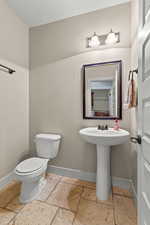 Bathroom with baseboards and stone tile floors