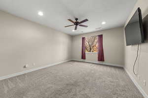 Unfurnished room featuring light colored carpet, ceiling fan, and recessed lighting