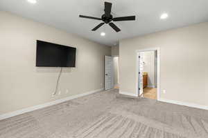 Unfurnished bedroom featuring recessed lighting, ceiling fan, light carpet, and connected bathroom