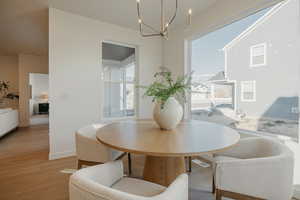 Dining room with wood finished floors and hanging lights