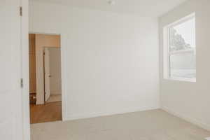 Unfurnished room with carpet flooring and baseboards