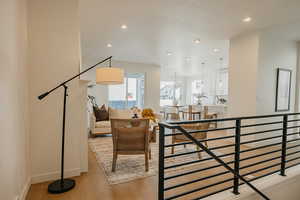 Living room featuring light wood finished floors and hanging lights