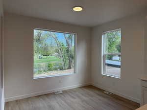 Spare room featuring baseboards and light wood-style floors