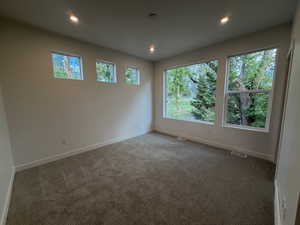 Carpeted spare room with recessed lighting