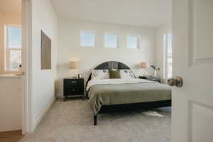 Bedroom featuring light colored carpet and baseboards
