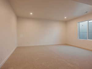 Unfurnished room featuring light colored carpet and recessed lighting