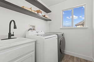 Laundry room featuring dark wood-style flooring and washer and clothes dryer