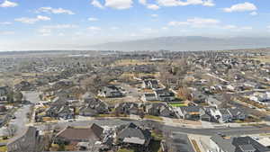 Aerial overview of property's location with a mountainous background and nearby suburban area