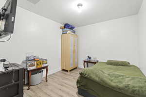 Bedroom with light wood-style floors and baseboards