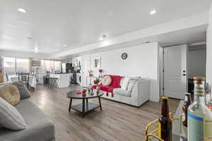 Living room featuring light wood-style floors and recessed lighting