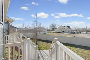 Fenced backyard featuring a residential view