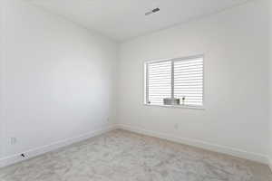 Unfurnished room with carpet and baseboards