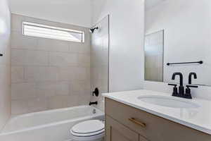 Bathroom with vanity and bathtub / shower combination