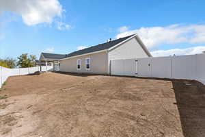 View of property exterior featuring a gate and a fenced backyard